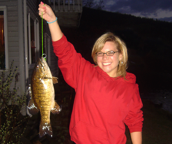 A very happy young lady after catching a nice fat bass in Wallace Pond located in Vermont's Northeast Kingdom (NEK) Photo of smiling girl after catching a nice fat bass in Wallace Pond located in Vermont's Northeast Kingdom (NEK).